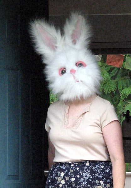 Meps, answering the door in a large and slightly disturbing rabbit head