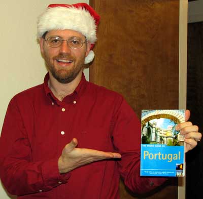 Barry in his Christmas hat with our Rough Guide to Portugal