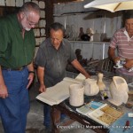 Alfredo Gonzales shows Philip some of the books he uses to reproduce ancient carvings.