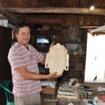 Gonzales' son displays one of the carvings in his studio.