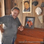 Master Carver Alfredo Gonzales, with his autographed photo of John Glenn. Gonzales' reproductions of ancient carvings are found in collections around the world.