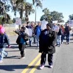 The parade heads down Gloucester Street in Brunswick, Georgia