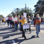 Unitarian Universalists of Coastal Georgia, led by Rev Jane Page, march past their church