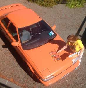 Orange Toyota GTS with Strangers Have the Best Candy magnets