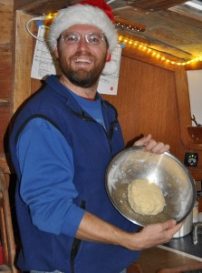 Barry shows off the dough in the bowl. It was cold enough to wear our Santa hats inside the boat.