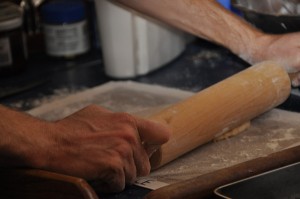 Barry's using our rolling pin on top of a silicone mat to roll the noodles.