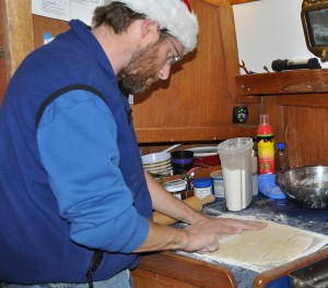 Barry uses a plastic knife to cut the dough into square noodles.