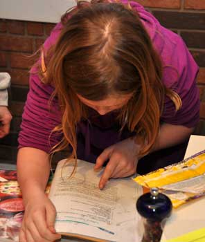 Cindy checks a cookie recipe before beginning to bake