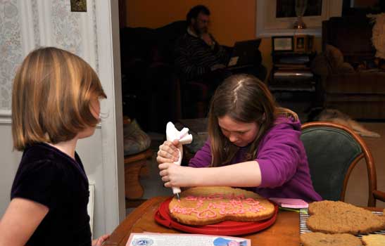 Becky watches as Cindy decorates our giant sugar cookie