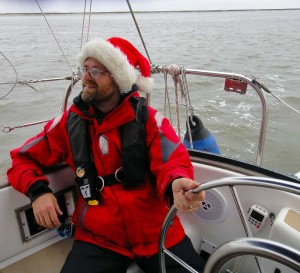 Barry wearing a Santa Claus hat and steering Flutterby