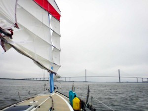 Flutterby's mainsail and the Sidney Lanier bridge in the distance