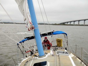 Deck of Flutterby under sail, with Meps at the helm