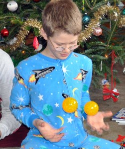 E plays with 2 smiley-face balls