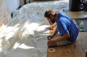 Barry sitting on the floor surrounded by white fabric