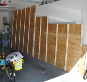 Plywood lofting floor leaning against the wall of the garage