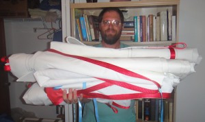 Barry holding a stack of folded sails