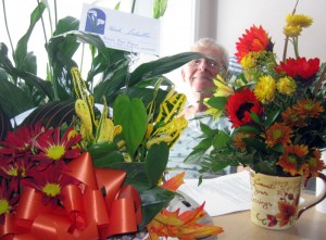 Dad in the hospital, surrounded by flowers from well-wishers