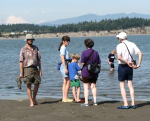 Barry, Julie, Gabriel, Sharon, Emanuel, and Dave wading at Iverson Spit with Mount Baker in the background