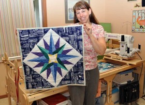 Karen with the compass rose side of the quilt