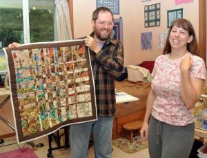 Barry holding the quilt, showing the landlubber side