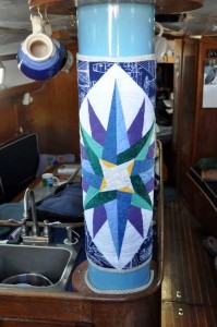 Mast inside the boat with quilt on it