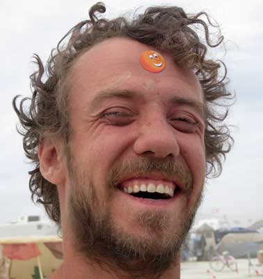 Man with happy orange sticker on his forehead