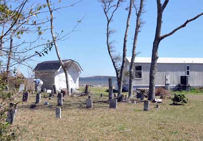 This cemetery is in the front yard of someone's single-wide mobile home