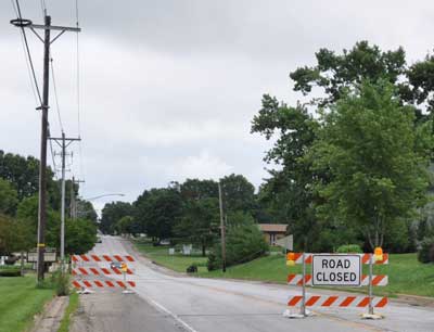 Empty street and road closed sign